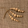 Image client Boules en bois non traité 15 mm ø 4 mm - paquet de 18. avec des trous
